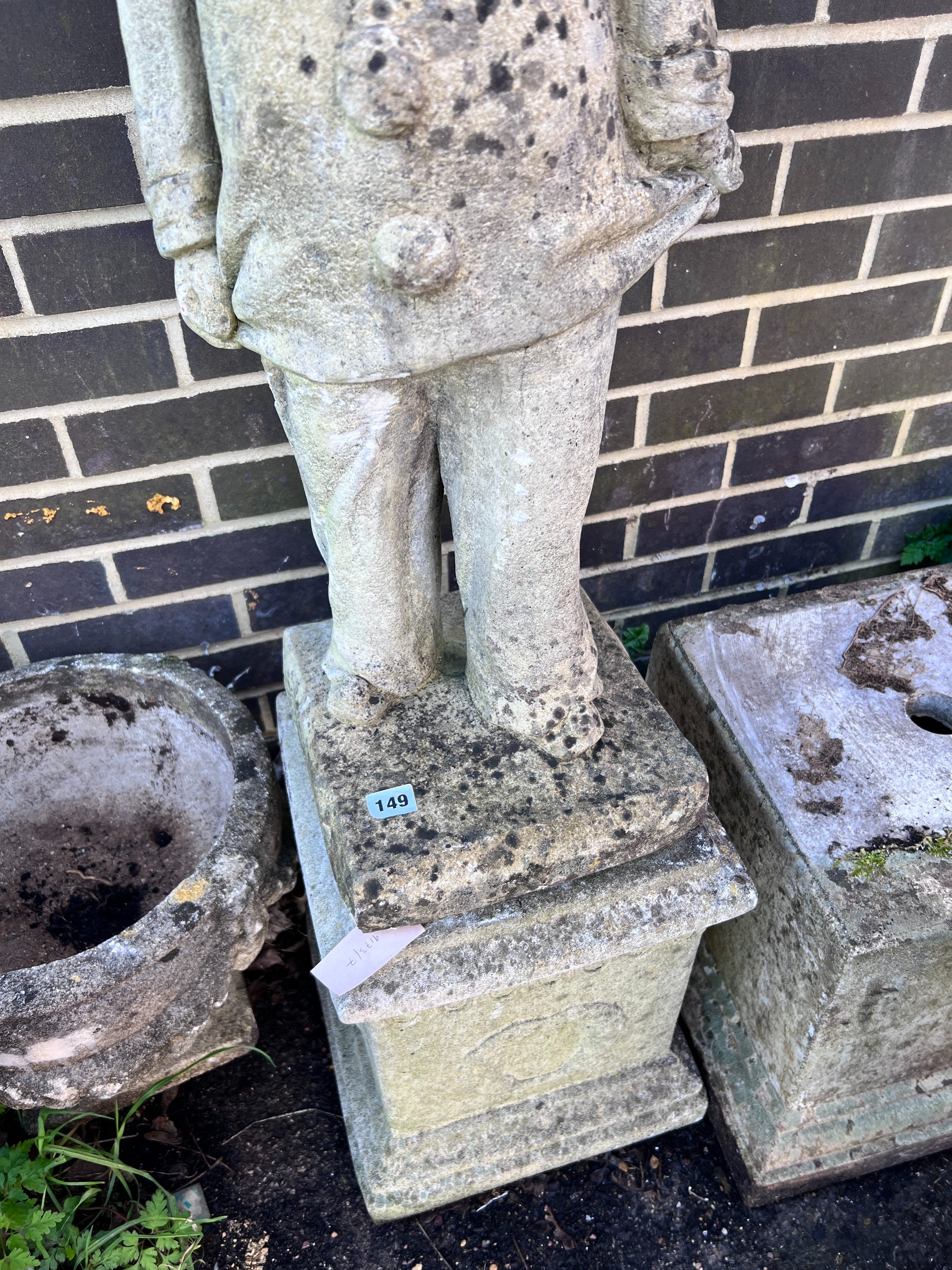 A reconstituted stone garden pierrot on square plinth, height 130cm *Please note the sale commences at 9am.